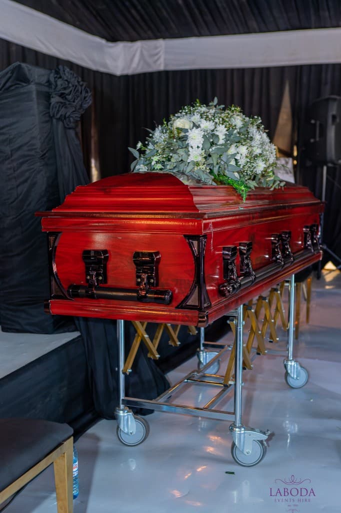 Casket with white floral tribute