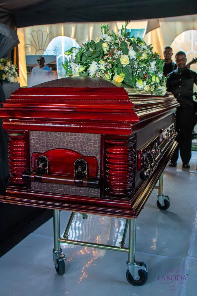 Casket with roses and greenery